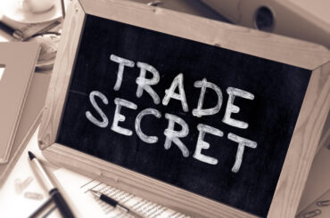 A small blackboard with 'Trade Secret' written on it, representing a blog focused on industry secrets and insider knowledge.