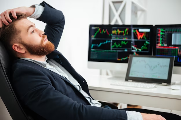 A person hesitantly analyzing market data on their computer screen, reflecting the anxiousness of making incorrect trading decisions.
