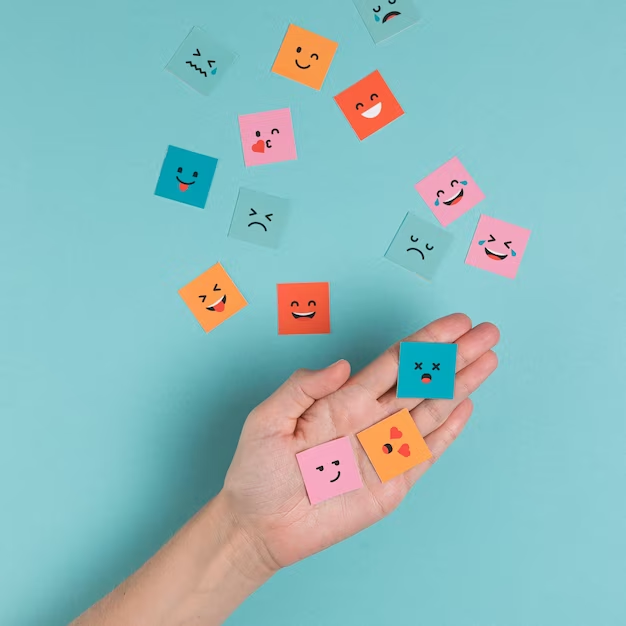 A hand holding a collection of square smiling faces, symbolizing positivity, happiness, and a sense of well-being.