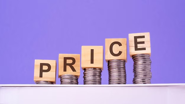 A photo showcasing wooden cubes with the word "price" on top, placed on a pile of coins, representing a business concept related to pricing and financial transactions.