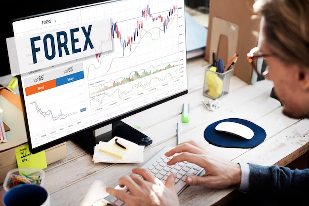 Forer Brokers - A person operating on his desktop where forex is written.
