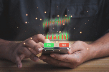 Close-up of a trader using a mobile app to follow social trading platforms, with a virtual stock chart and prominent Buy/Sell buttons. 2026 trading guide context.