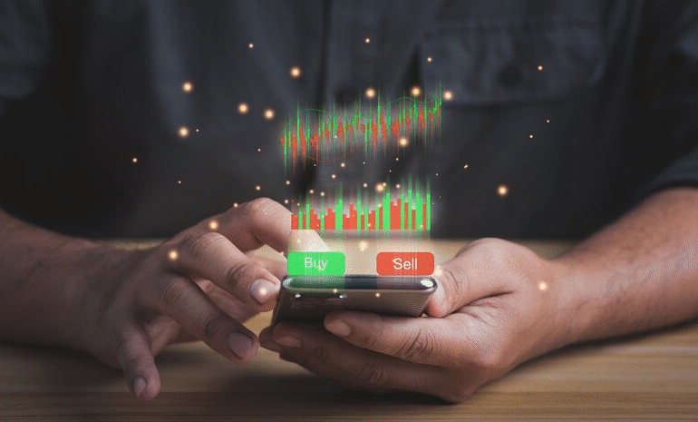 Close-up of a trader using a mobile app to follow social trading platforms, with a virtual stock chart and prominent Buy/Sell buttons. 2026 trading guide context.