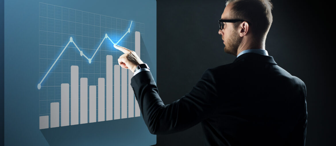 A professional trader in a suit analyzing a bullish growth chart and bar graph on a digital interface, symbolizing strategic risk management.