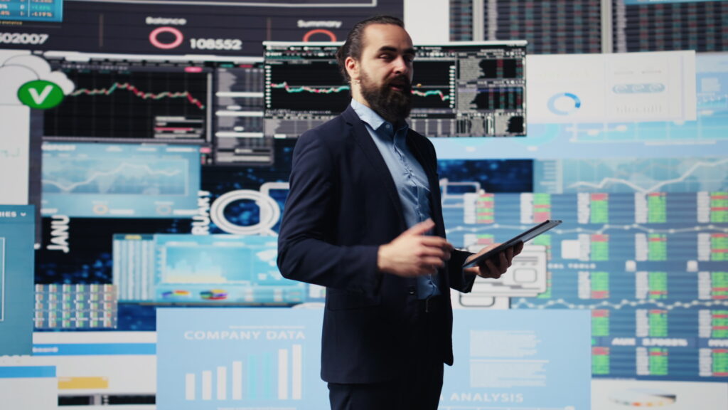 Professional trader presenting best strategies for commodity trading with market data and charts on display screens