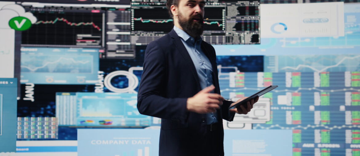 Professional trader presenting best strategies for commodity trading with market data and charts on display screens