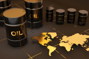 Black crude oil barrels arranged next to a gold world map representing the Brent Crude Oil global benchmark.