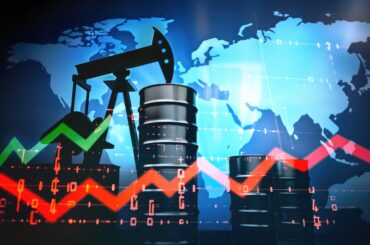 An oil pump jack and crude oil barrels set against a world map overlay with financial market line graphs representing Brent Crude Oil vs WTI price movements.